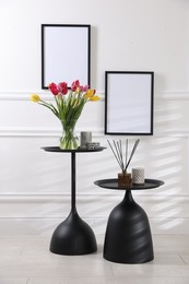 Photo of Bouquet of beautiful tulips and decor on tables indoors