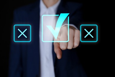 Image of Approved. Man choosing check mark on virtual screen against black background, closeup