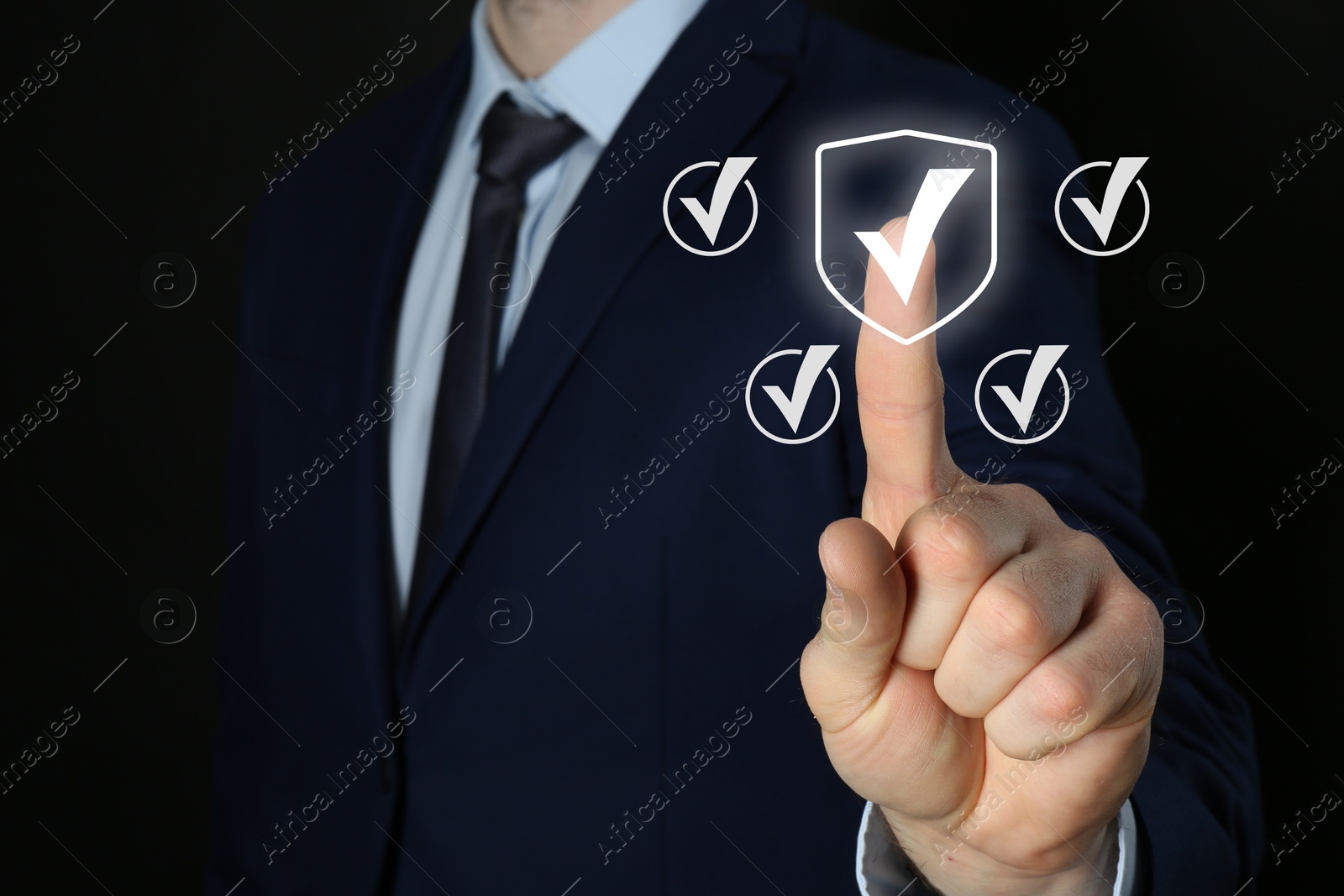 Approved. Man touching check mark on virtual screen against black background, closeup Image of Approved. Man touching check mark on virtual screen against black background, closeup