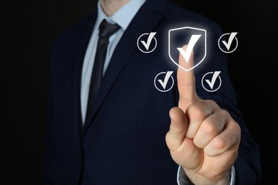 Image of Approved. Man touching check mark on virtual screen against black background, closeup