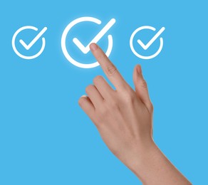 Image of Approved. Woman touching check mark on virtual screen against light blue background, closeup