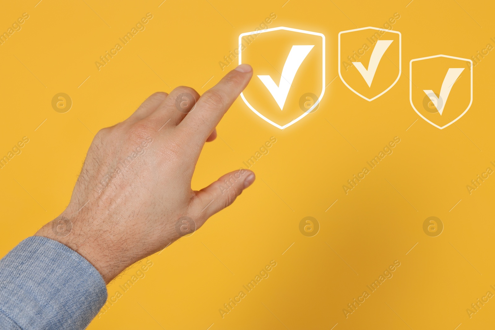 Approved. Man touching check mark on virtual screen against orange background, closeup Image of Approved. Man touching check mark on virtual screen against orange background, closeup