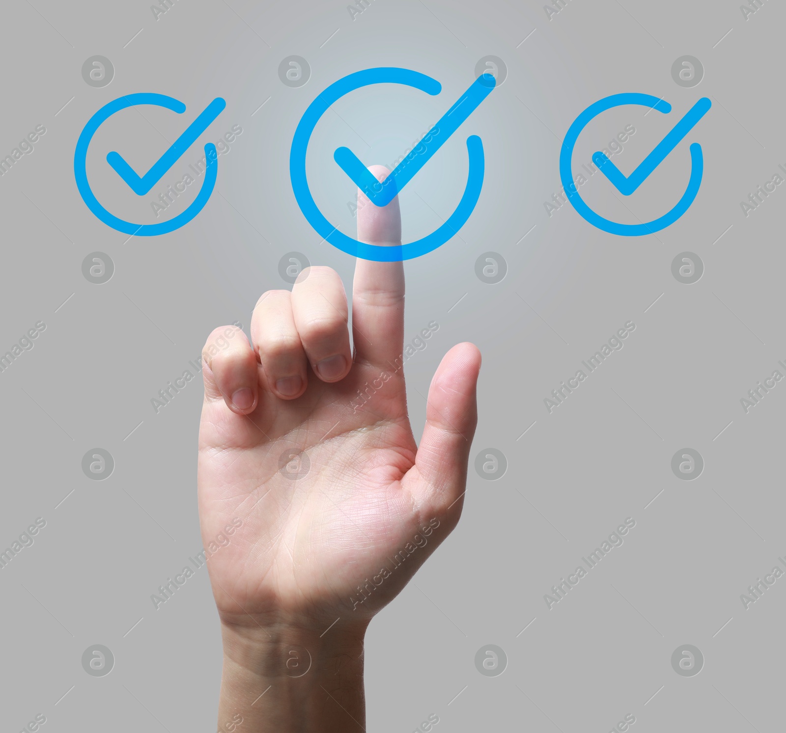 Approved. Man touching check mark on virtual screen against light grey background, closeup Image of Approved. Man touching check mark on virtual screen against light grey background, closeup
