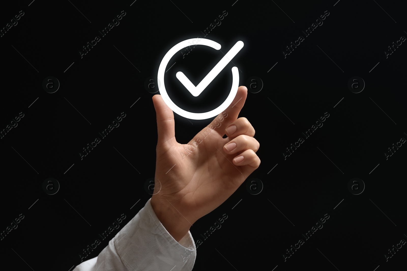 Approved. Woman holding virtual check mark in hand on black background, closeup Image of Approved. Woman holding virtual check mark in hand on black background, closeup