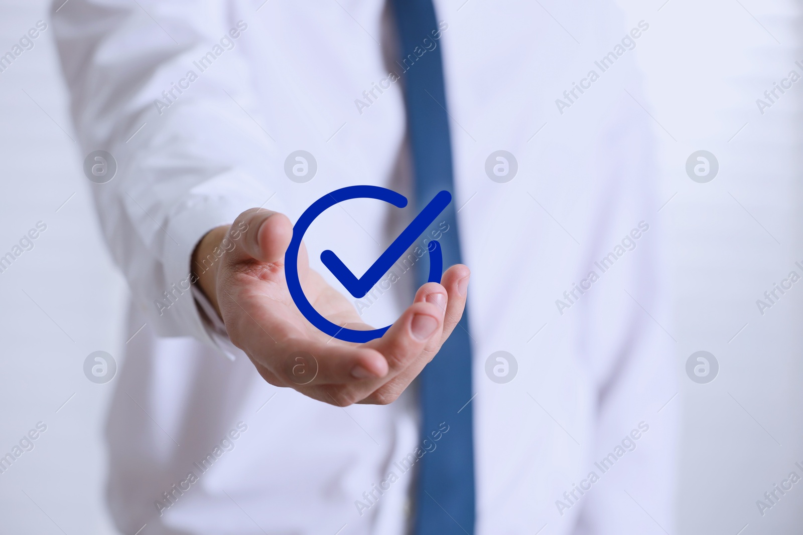 Approved. Man holding virtual check mark in hand on white background, closeup Image of Approved. Man holding virtual check mark in hand on white background, closeup