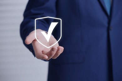Image of Approved. Man holding virtual check mark in hand, closeup