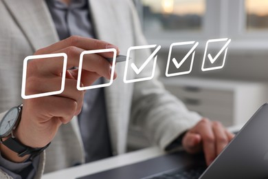 Image of Approved. Man using laptop and checking boxes on virtual screen, closeup