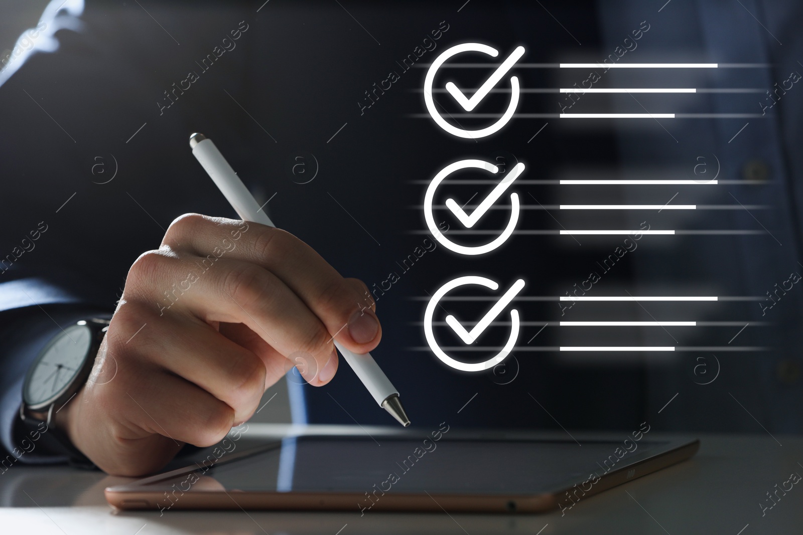 Approved. Man using tablet at table, closeup. Check marks above device Image of Approved. Man using tablet at table, closeup. Check marks above device