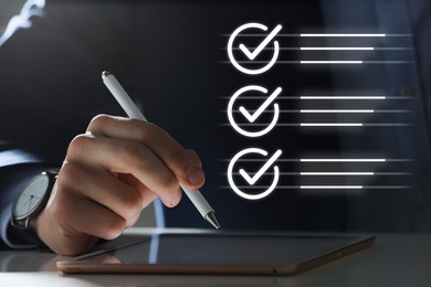 Image of Approved. Man using tablet at table, closeup. Check marks above device