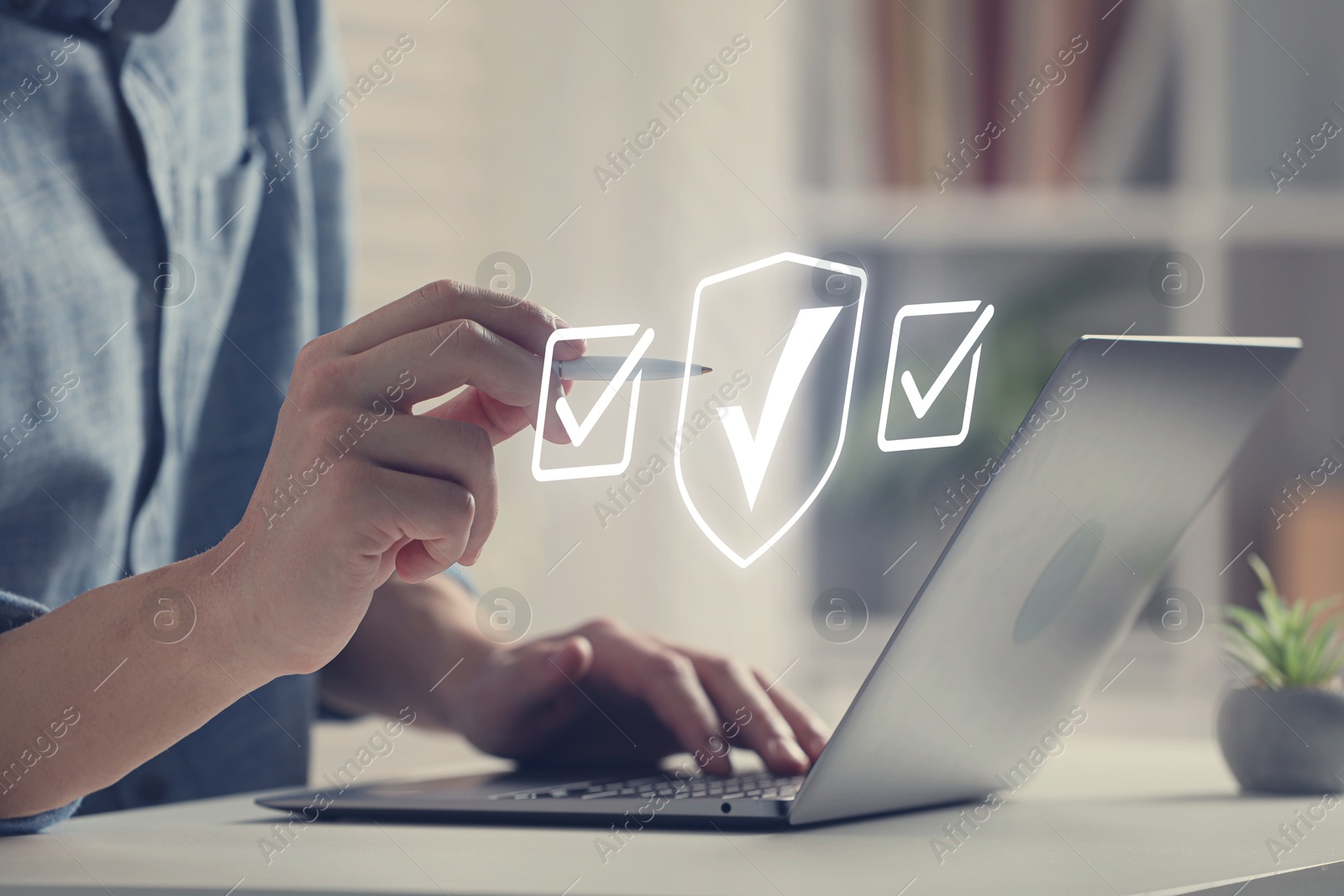 Approved. Man using laptop and touching virtual screen with check marks at table, closeup Image of Approved. Man using laptop and touching virtual screen with check marks at table, closeup