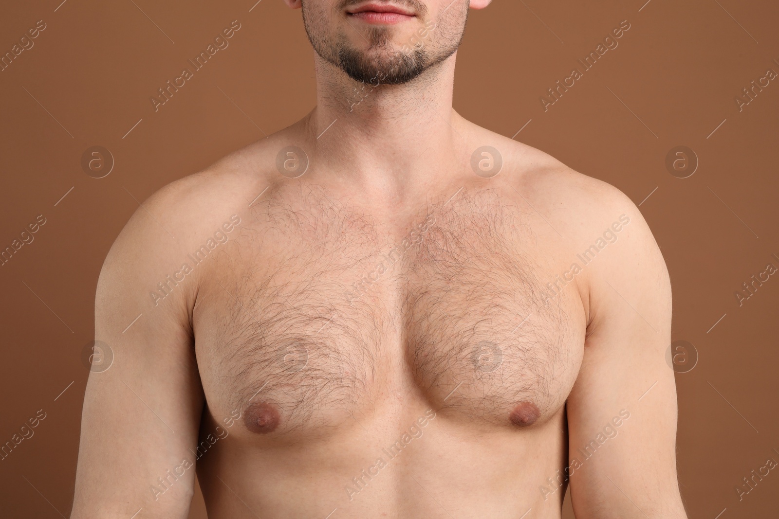 Young man with hairy chest on brown background, closeup. Epilation procedure Photo of Young man with hairy chest on brown background, closeup. Epilation procedure