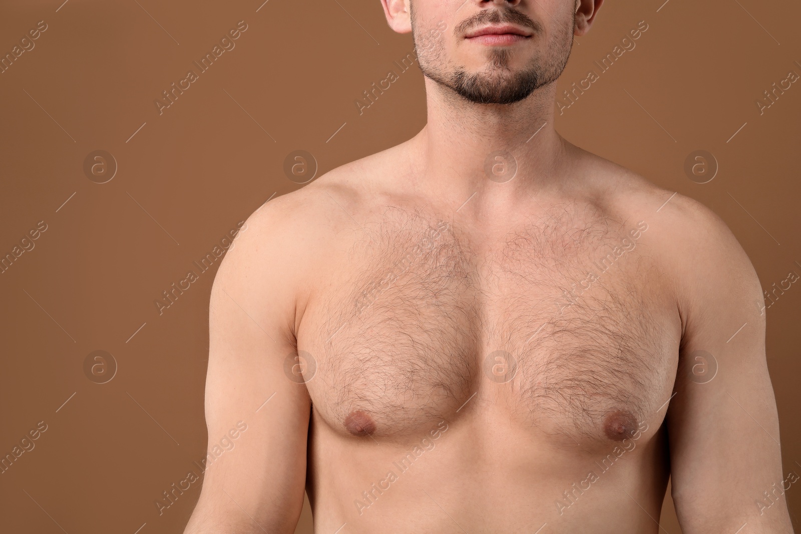 Young man with hairy chest on brown background, closeup. Epilation procedure Photo of Young man with hairy chest on brown background, closeup. Epilation procedure