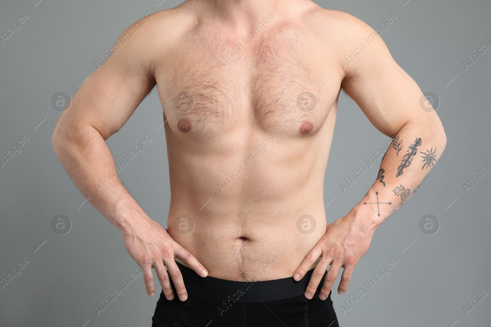Young man with hairy chest on light grey background, closeup. Epilation procedure Photo of Young man with hairy chest on light grey background, closeup. Epilation procedure