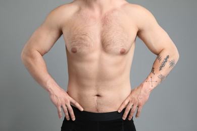 Photo of Young man with hairy chest on light grey background, closeup. Epilation procedure