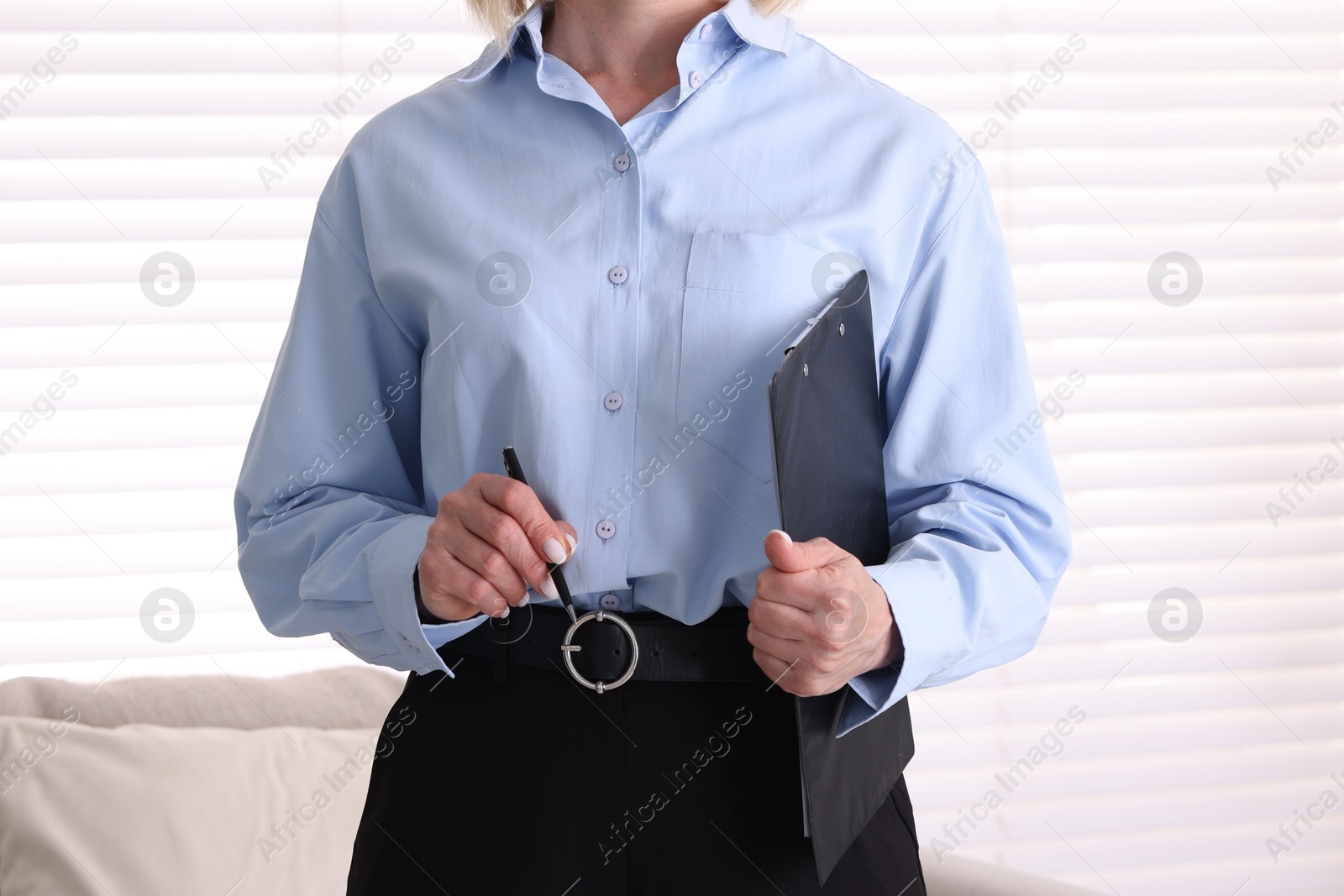 Professional psychologist with clipboard and pen in office, closeup Photo of Professional psychologist with clipboard and pen in office, closeup