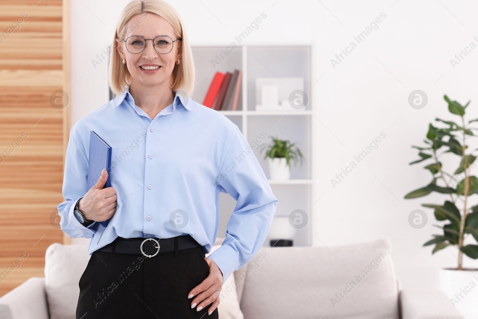Professional psychologist with notebook in office, space for text Photo of Professional psychologist with notebook in office, space for text