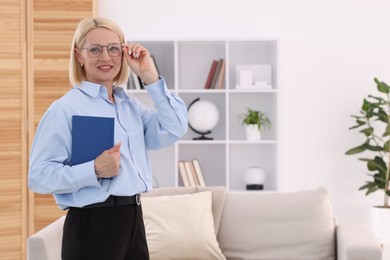 Photo of Professional psychologist with notebook in office, space for text