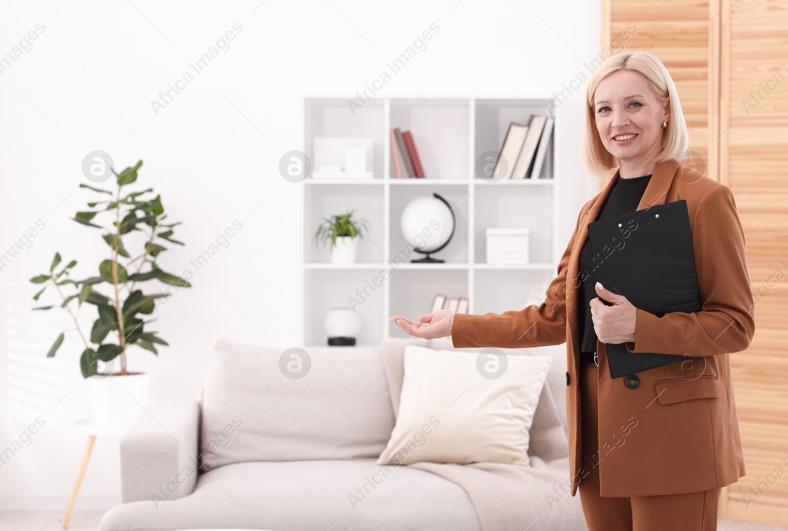 Professional psychologist with clipboard in office, space for text Photo of Professional psychologist with clipboard in office, space for text