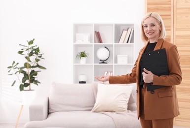Photo of Professional psychologist with clipboard in office, space for text