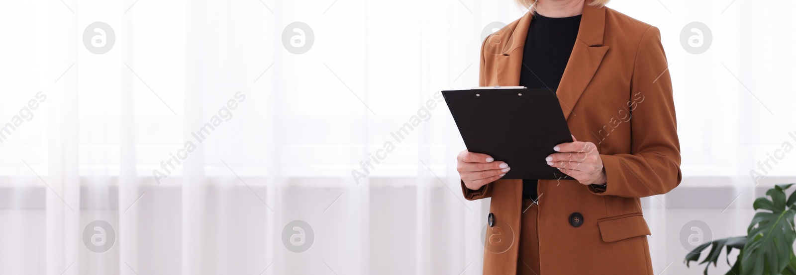 Professional psychologist with clipboard in office, closeup. Space for text Photo of Professional psychologist with clipboard in office, closeup. Space for text