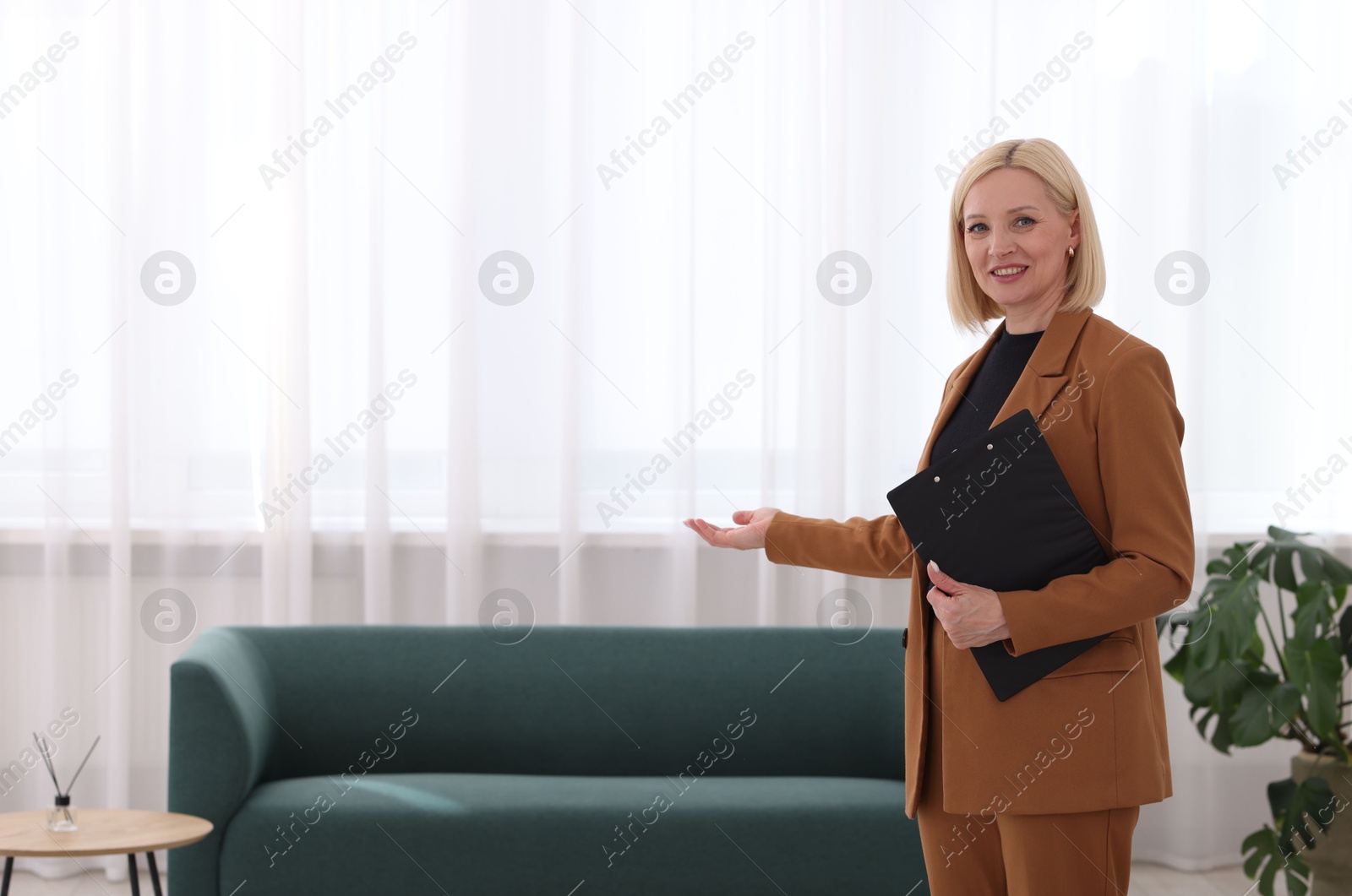 Professional psychologist with clipboard in office, space for text Photo of Professional psychologist with clipboard in office, space for text