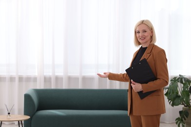 Photo of Professional psychologist with clipboard in office, space for text