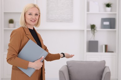 Photo of Professional psychologist with documents in office, space for text