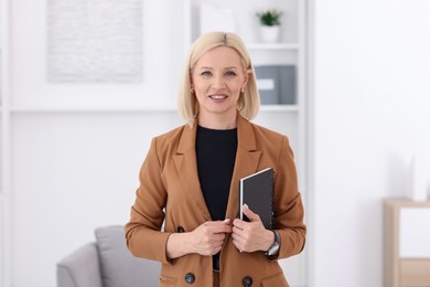 Photo of Portrait of professional psychologist with notebook in office