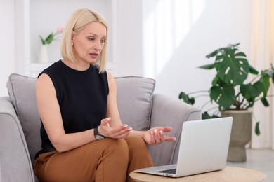 Photo of Professional psychologist working with laptop in office