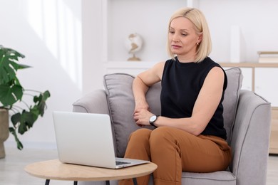 Photo of Professional psychologist working with laptop in office