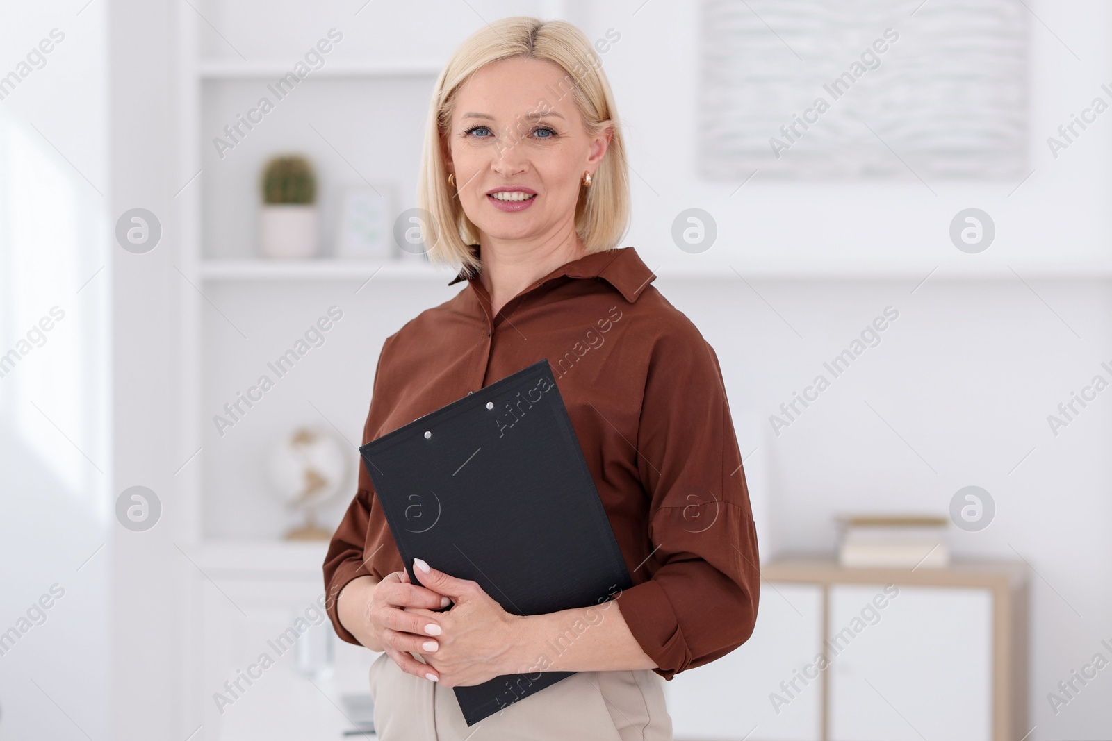 Portrait of professional psychologist with clipboard in office Photo of Portrait of professional psychologist with clipboard in office