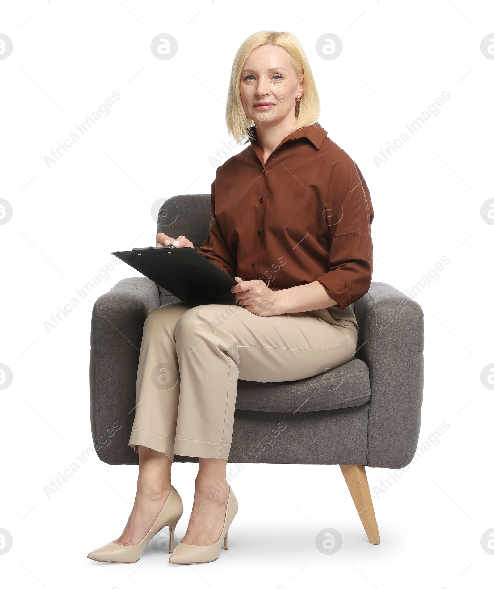 Professional psychologist with clipboard in armchair on white background Photo of Professional psychologist with clipboard in armchair on white background