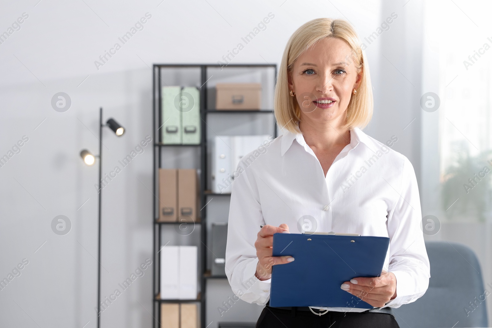 Professional psychologist with clipboard in office, space for text Photo of Professional psychologist with clipboard in office, space for text