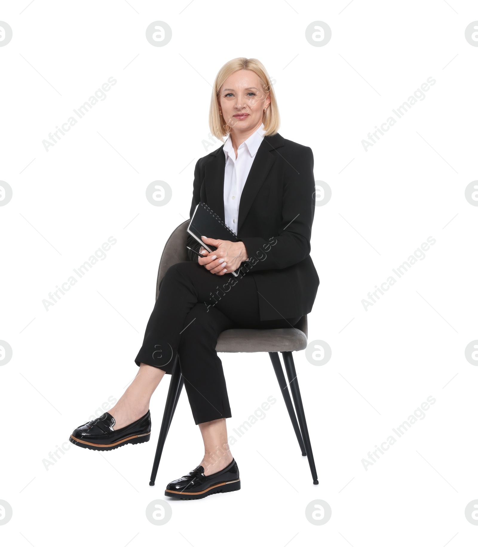 Professional psychologist with notebook on chair against white background Photo of Professional psychologist with notebook on chair against white background