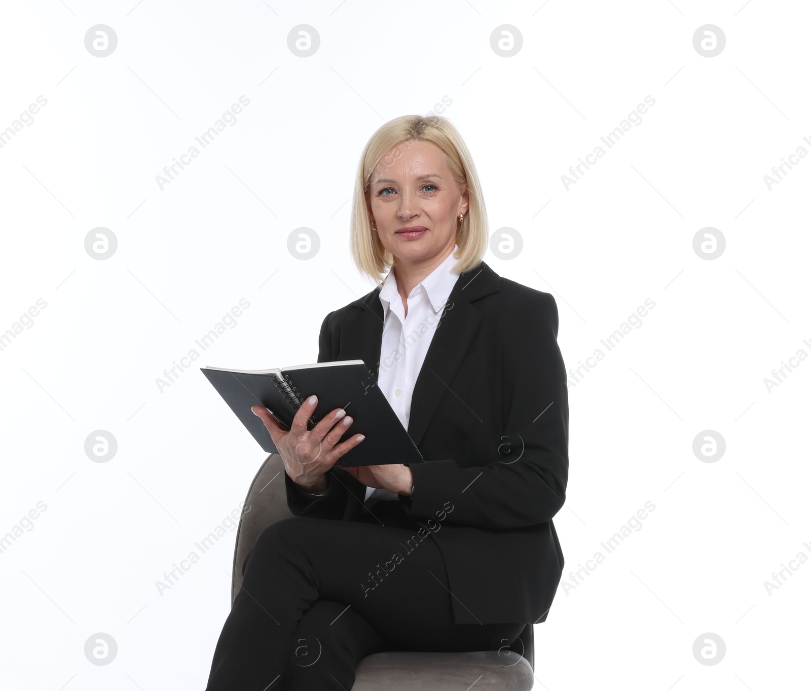 Professional psychologist with notebook on chair against white background Photo of Professional psychologist with notebook on chair against white background