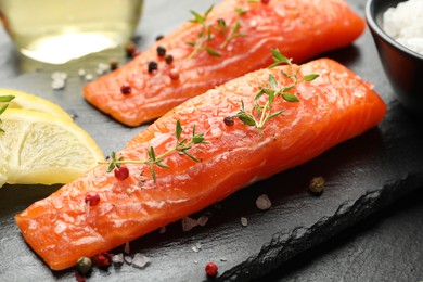 Photo of Seafood. Pieces of salmon fillet, spices and lemon on table, closeup
