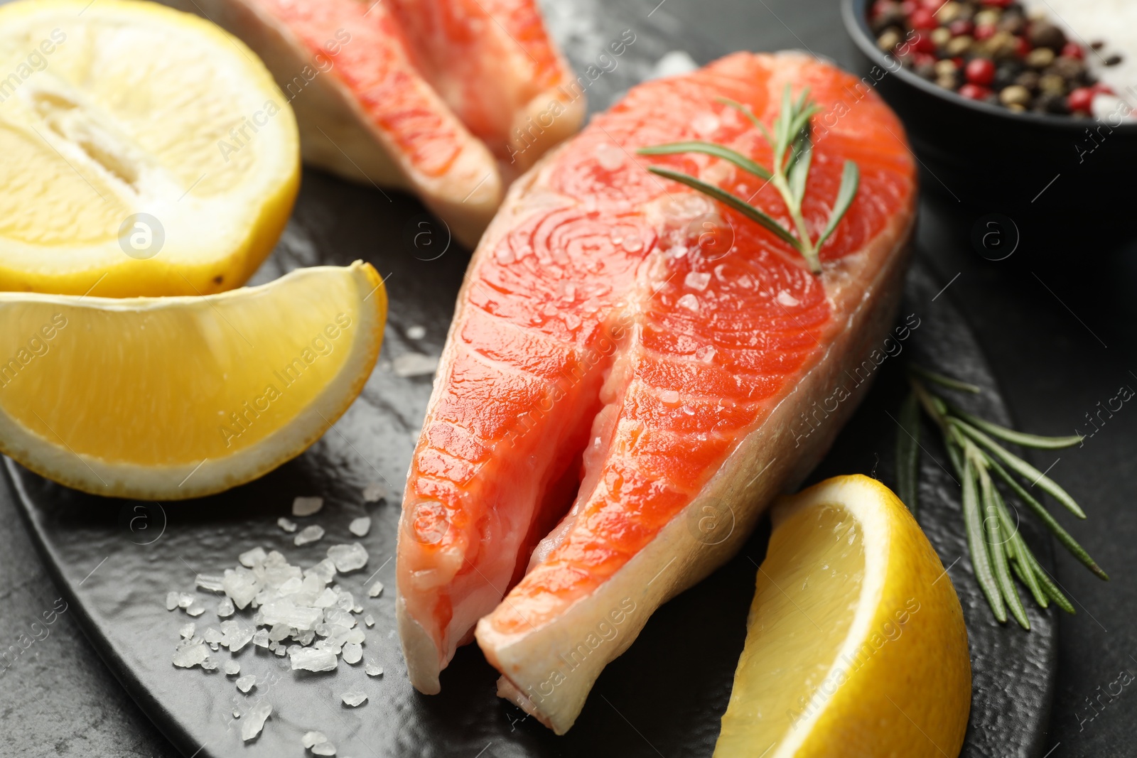 Seafood. Salmon steaks, spices and lemon on table, closeup Photo of Seafood. Salmon steaks, spices and lemon on table, closeup