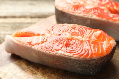 Photo of Seafood. Fresh raw salmon steaks on table, closeup