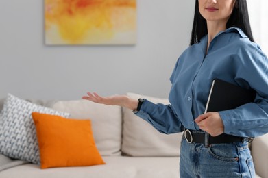 Photo of Professional psychologist with notebook in office, closeup