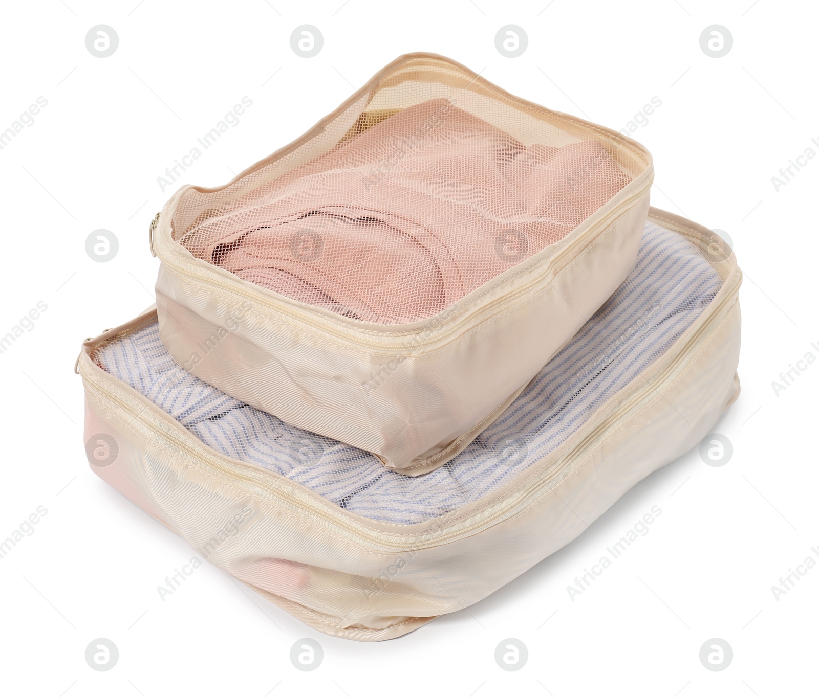 Beige packing cubes with folded clothes isolated on white Photo of Beige packing cubes with folded clothes isolated on white