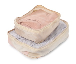 Photo of Beige packing cubes with folded clothes isolated on white