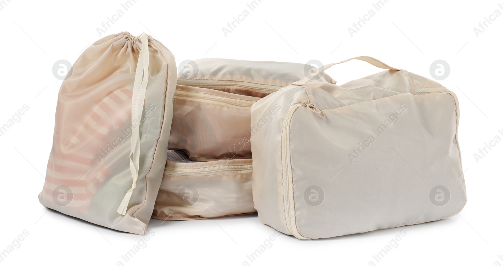 Beige packing cubes with clothes isolated on white Photo of Beige packing cubes with clothes isolated on white