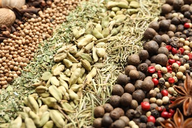 Photo of Many different spices as background, closeup view