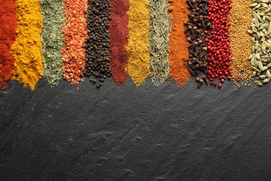 Photo of Many different spices on black table, flat lay. Space for text