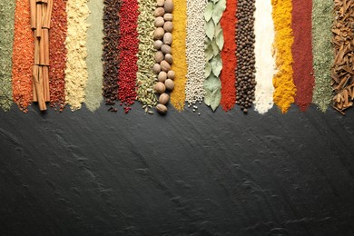 Photo of Many different spices on black table, flat lay. Space for text