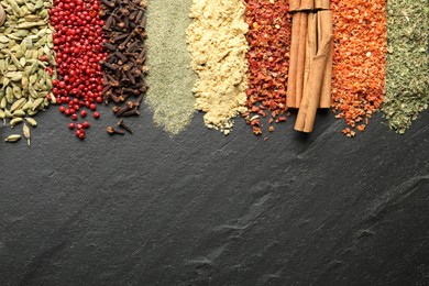 Photo of Many different spices on black table, flat lay. Space for text