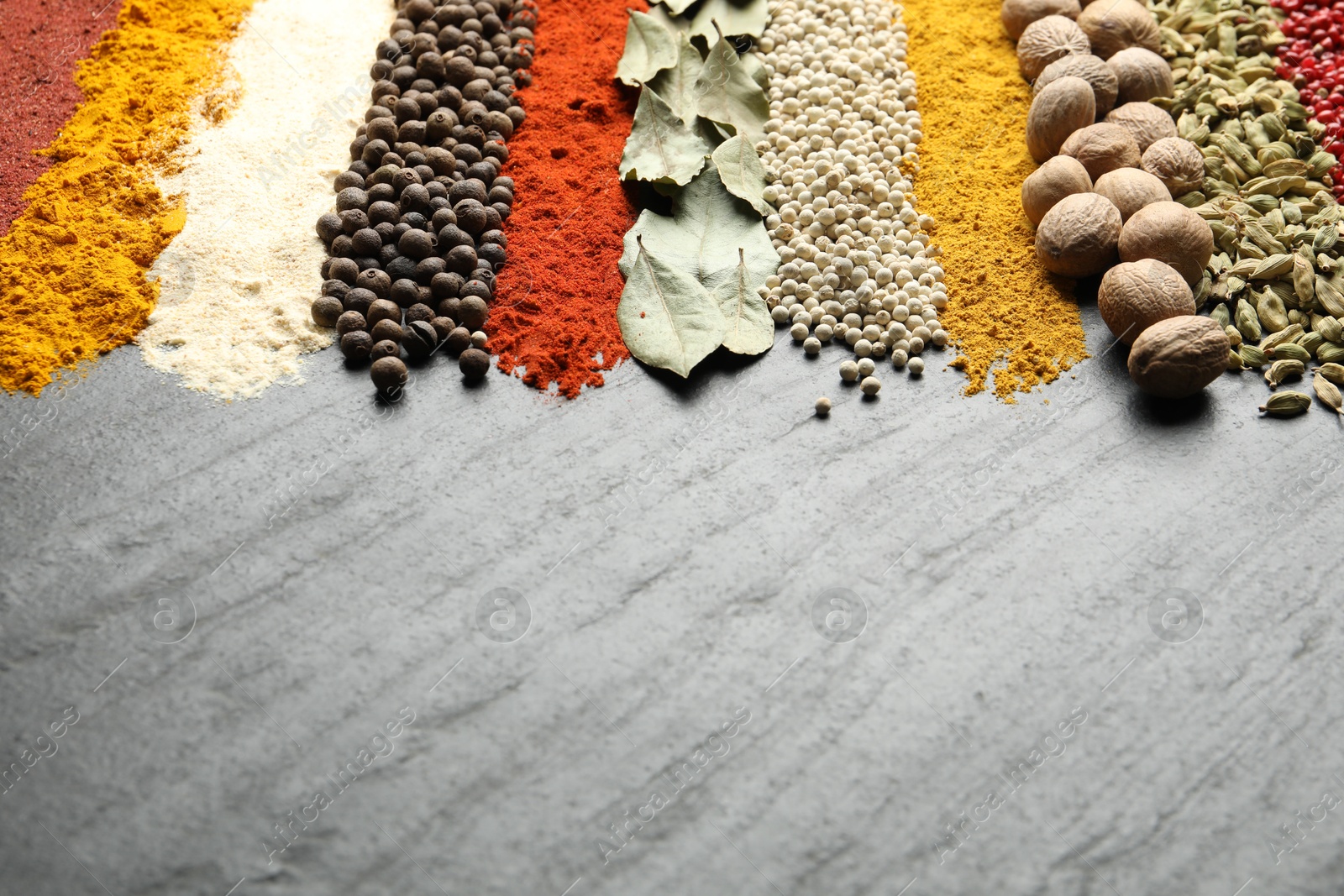 Many different spices on dark table, closeup. Space for text Photo of Many different spices on dark table, closeup. Space for text