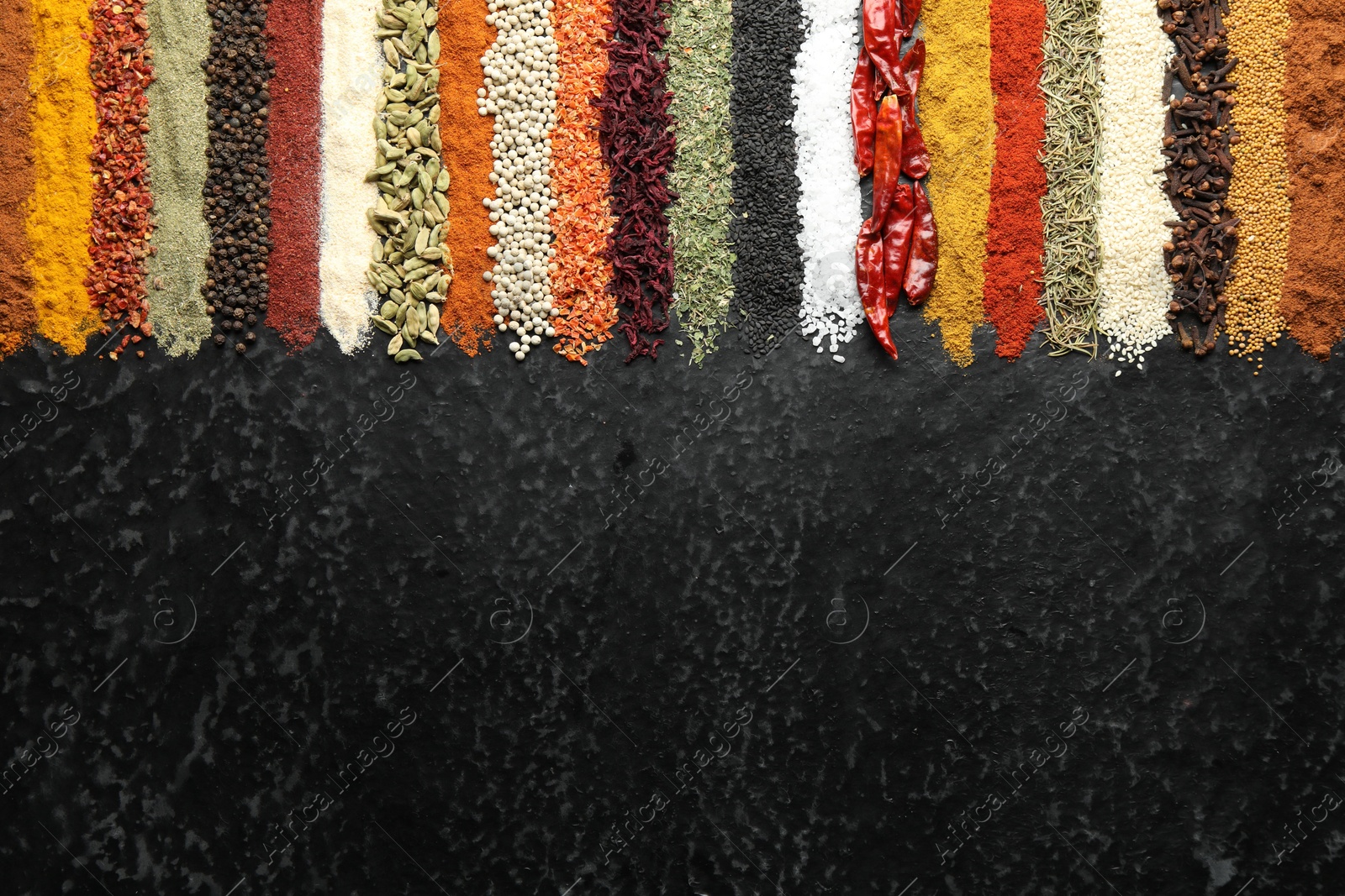 Many different spices on black table, flat lay. Space for text Photo of Many different spices on black table, flat lay. Space for text