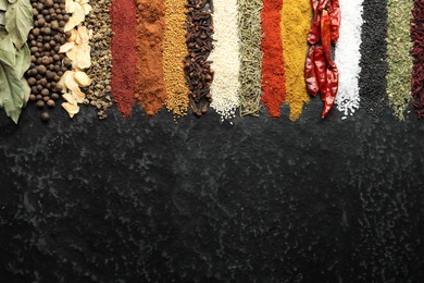 Photo of Many different spices on black table, flat lay. Space for text