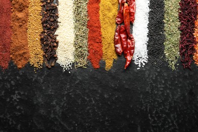 Photo of Many different spices on black table, flat lay. Space for text